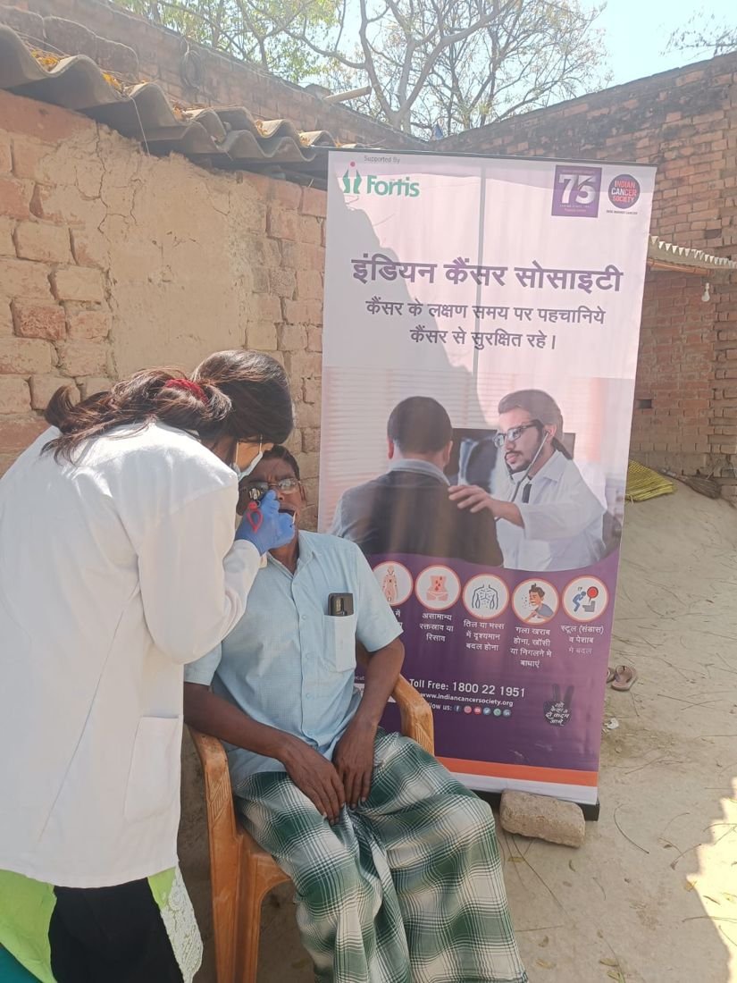 A health worker examines a man at the screening camp