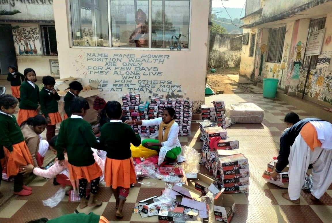 Students receiving new school shoes at a girls school in Madhya Pradesh